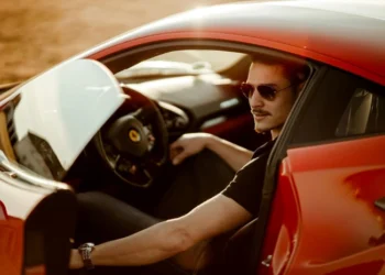 man in black shirt sitting in red car