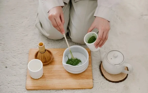 a person making traditional matcha tea