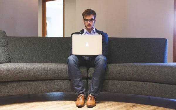 a man finding tips to build a business on laptop