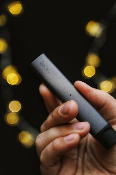 man holding logic vape pen