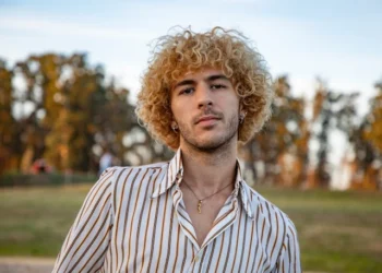 a man with white shirt wearing earing